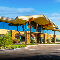 office building entrance with vehicle driveway in foreground