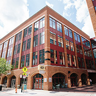 brick and glass building with brick sidewalk