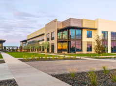 exterior building with grass and sidewalk in foreground