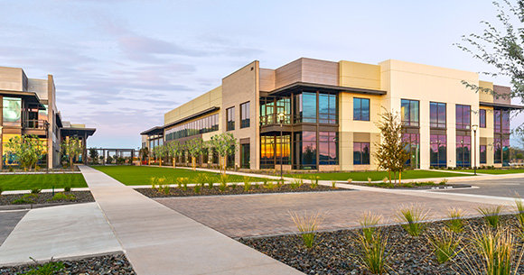 exterior building with grass and sidewalk in foreground