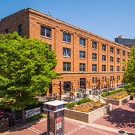 brick building with trees and brick plaza