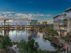 Four story office buildings and lake at Rivulon