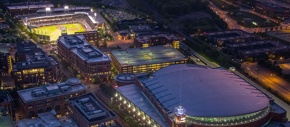 aerial view of ballpark and arena at night